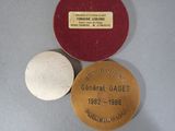 three medals are sitting on a table next to each other