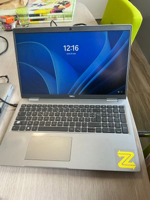 a laptop that is sitting on a table with a charger