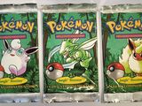 three packs of pokemon trading cards sitting on top of a table