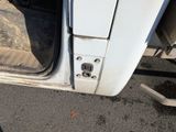 a white truck with the door open on the street