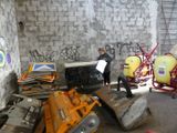 a man that is standing in a room with a lot of stuff