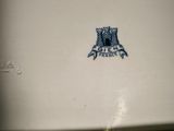 a close up of a blue and white plate with an owl on it