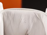 a close up view of a bed with a white comforter on it