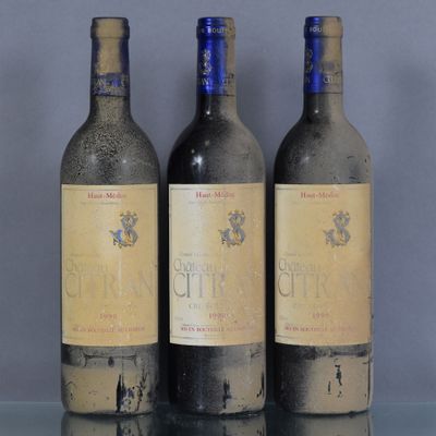 trois bouteilles de vin posées sur une table l'une à côté de l'autre