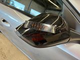 a sticker on the side mirror of a silver car