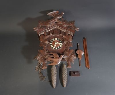 a clock that is hanging on the wall next to a pencil