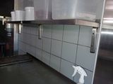 a picture of a kitchen with a lot of clutter on the counter
