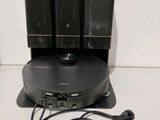 an image of three speakers and a charger on a stand