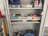a vacuum that is on the floor next to a cabinet