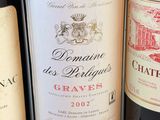 several bottles of wine are lined up on a table