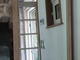 a mirror in the corner of a room next to a door