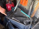 a man standing next to a cart with a bag on it