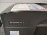a printer that is sitting on a desk with a sticker on it