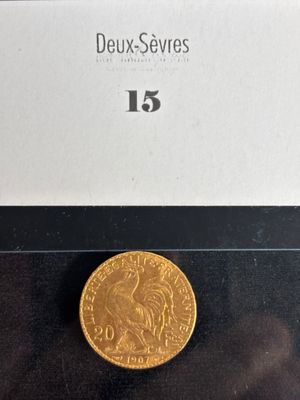 a close up of a gold coin on a black surface