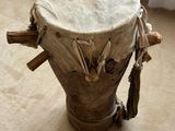a wooden drum sitting on the floor in front of a window