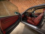 a car with its door open and the driver ' s seat up