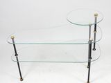 a glass and brass coffee table with three tiered shelves