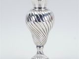an image of a silver vase sitting on top of a table
