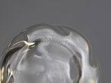 a clear glass vase with a gold decoration on it