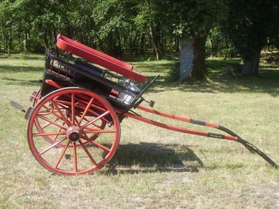 a red wagon that is sitting in the grass