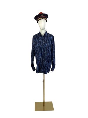 shirt on a mannequin stand with a hat on top of it