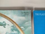 two books on a shelf with a rainbow in the sky