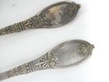 two spoons sitting next to each other on a table