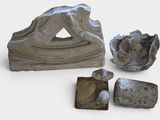 three pieces of stone that are sitting on a white surface