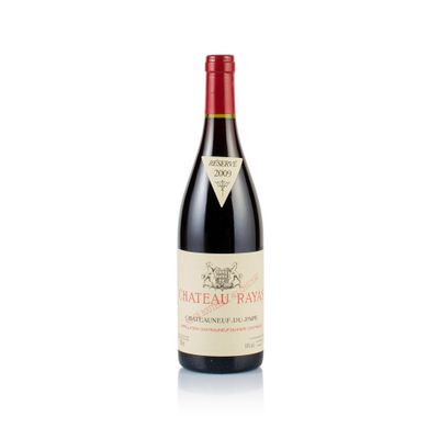 a bottle of red wine sitting on top of a white table