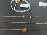 a table topped with lots of different types of bracelets