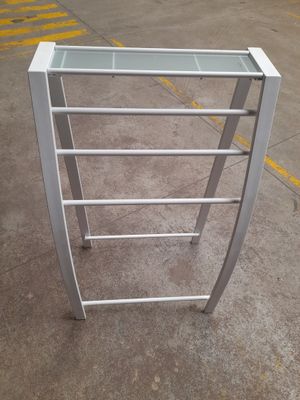 a metal rack that has a glass top on it