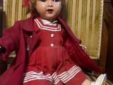 a small doll sitting on a chair in a room