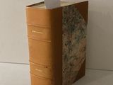 un livre marron contenant un mot, posé sur une table