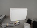 a white box with a power cord, a charger, and a charger plugged into it