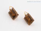 pair of earrings with a picture of a woman and a man on them