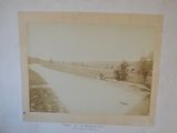 an old photo of a river running through a rural countryside