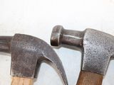two hammers that are sitting next to each other on a table