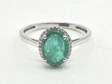 an image of a ring with a green stone in it
