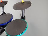 three drums sitting on top of a stand in a room