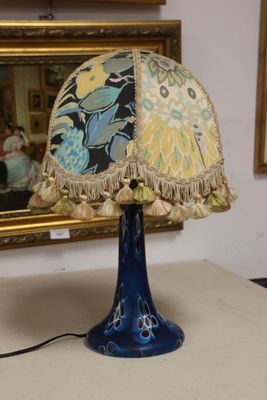 a lamp that is on a table in front of a mirror