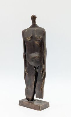 an image of a bronze statue of a man standing on a wooden base