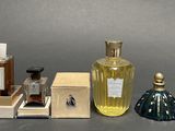 several bottles of perfume sitting next to each other on a table