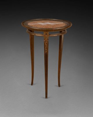 a small table with a marble top and wooden legs