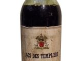 bottle of red wine sitting on a white surface with a white background