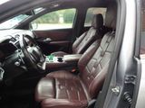 the interior of a car with brown leather seats and a center console