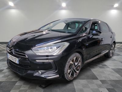 une voiture noire est garée sur le sol en damier d'un garage