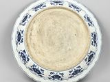 blue and white plate with floral designs on it on a gray surface