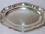 silver plate with scalloped edge on a white surface