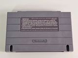 an old nintendo game console sitting on top of a white table