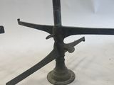 a pair of antique iron candlesticks with a bird on them